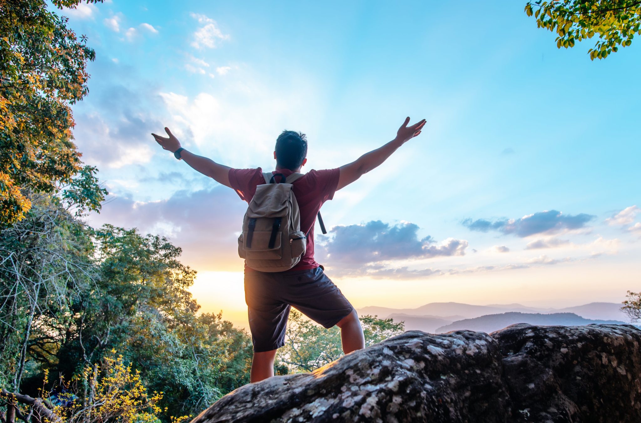 Person celebrating on mountaintop